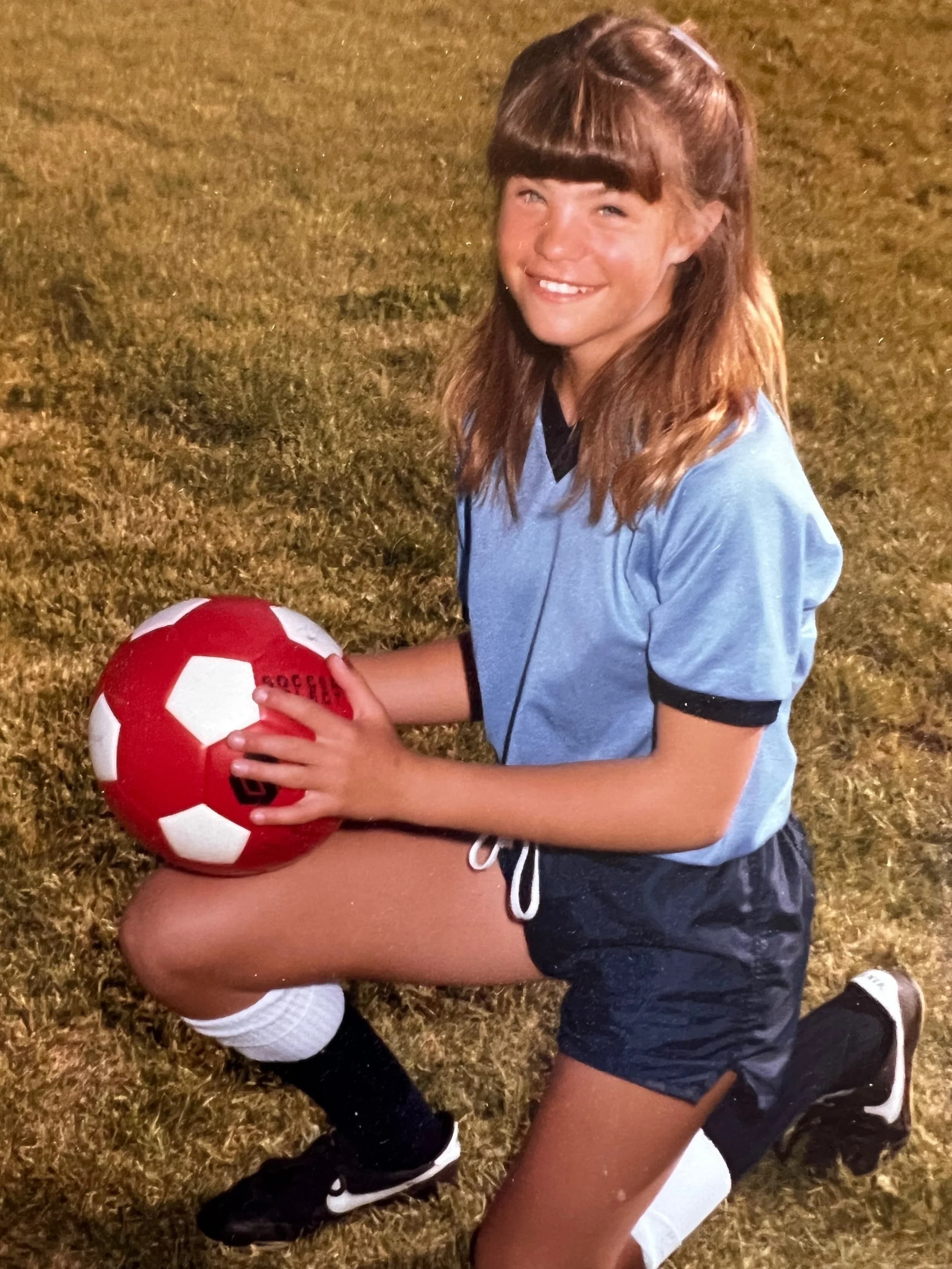 Young Angela playing soccer
